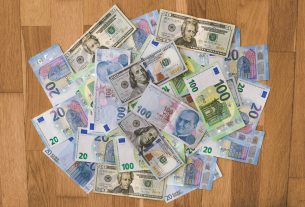 10 and 20 banknotes on brown wooden table