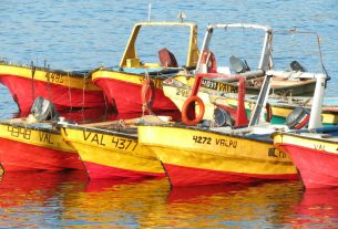 several yellow and red boats on water