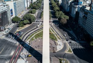 cars on road near city buildings during daytime